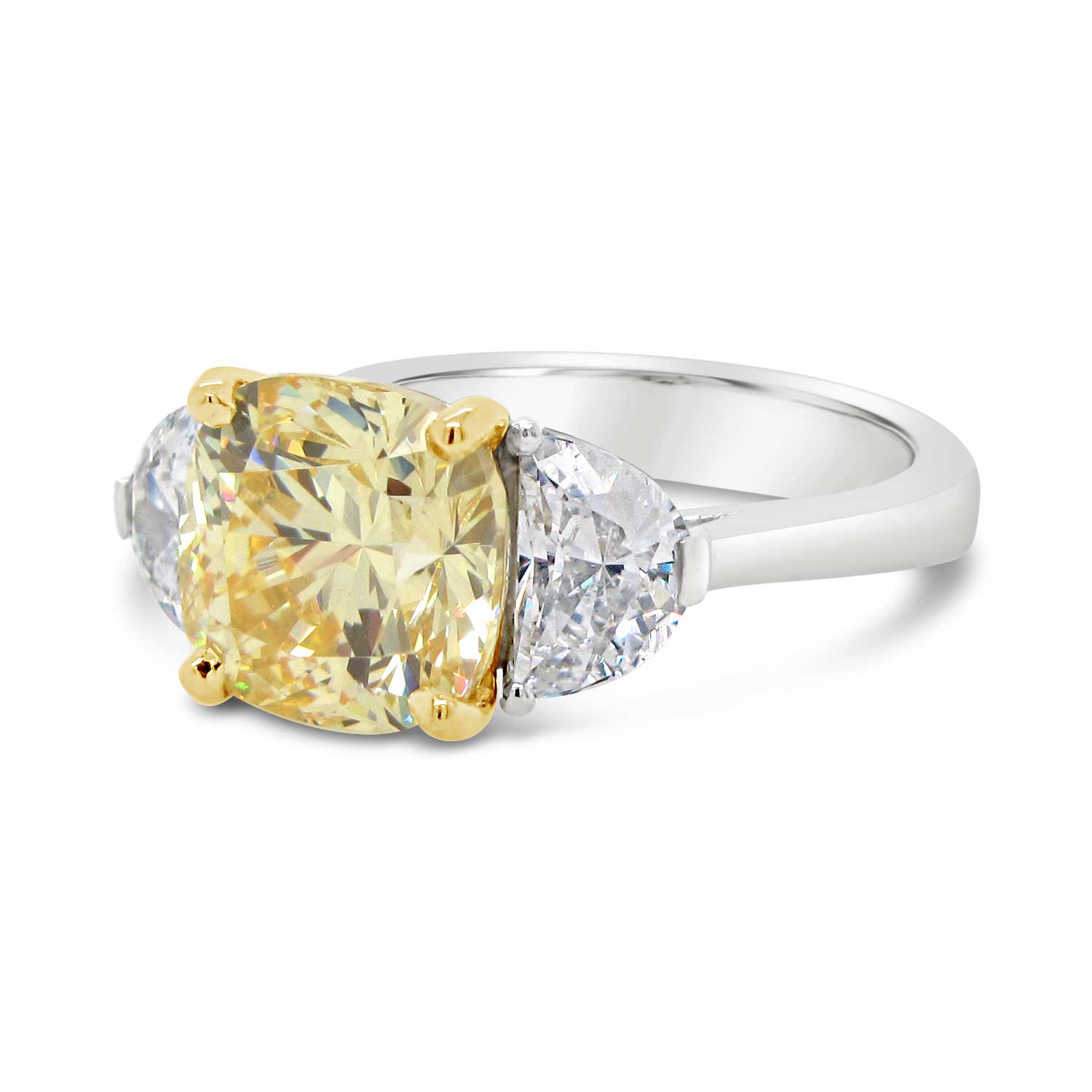 3ct yellow cushion cut center stone with two half-moon cut side stones set in 18k yellow gold and platinum