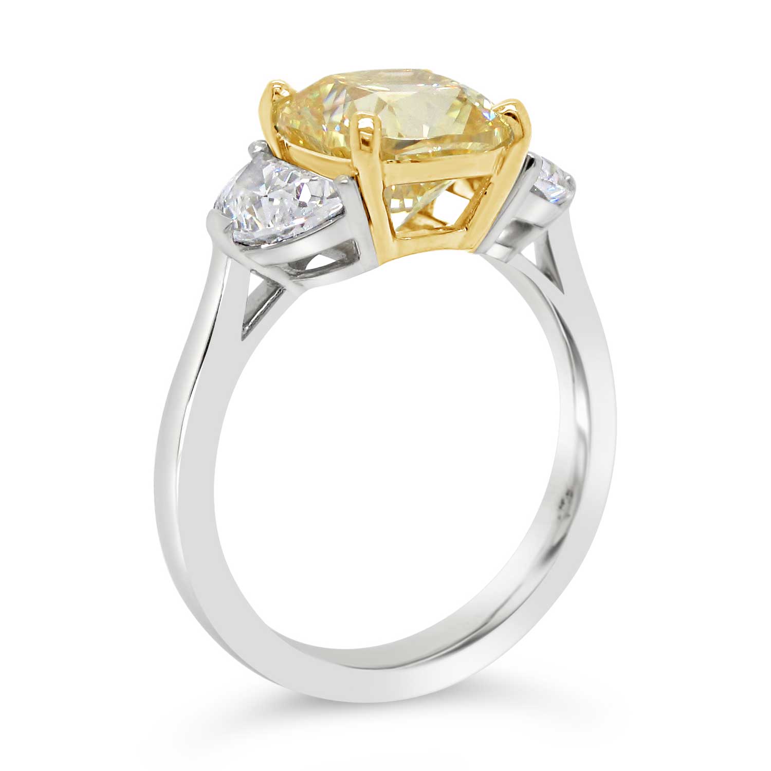3ct yellow cushion cut center stone with two half-moon cut side stones set in 18k yellow gold and platinum